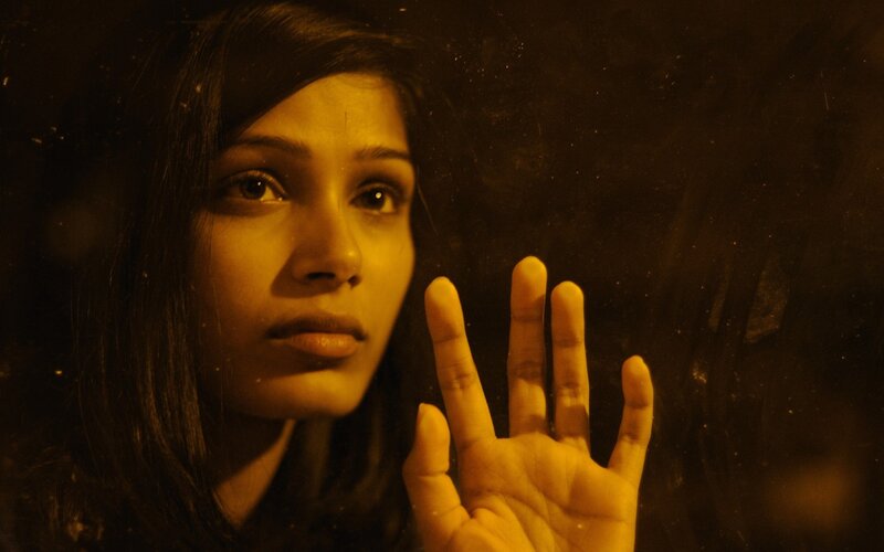 woman with hand on glass