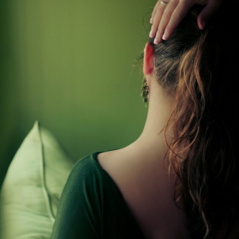 woman with hand on head
