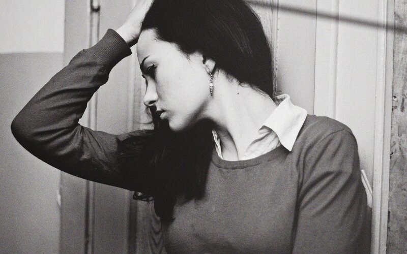 woman with hand on head