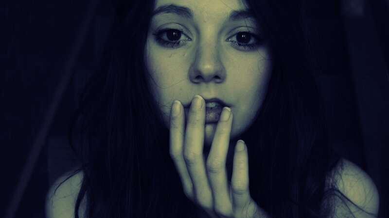 woman with hand over mouth