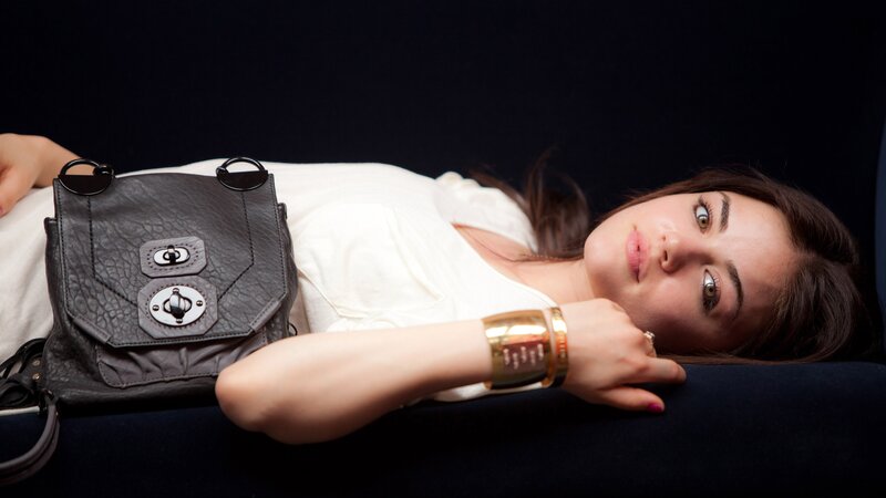 woman with handbag lying down