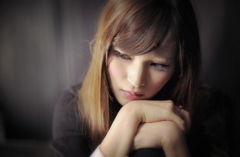 woman with hands clasped