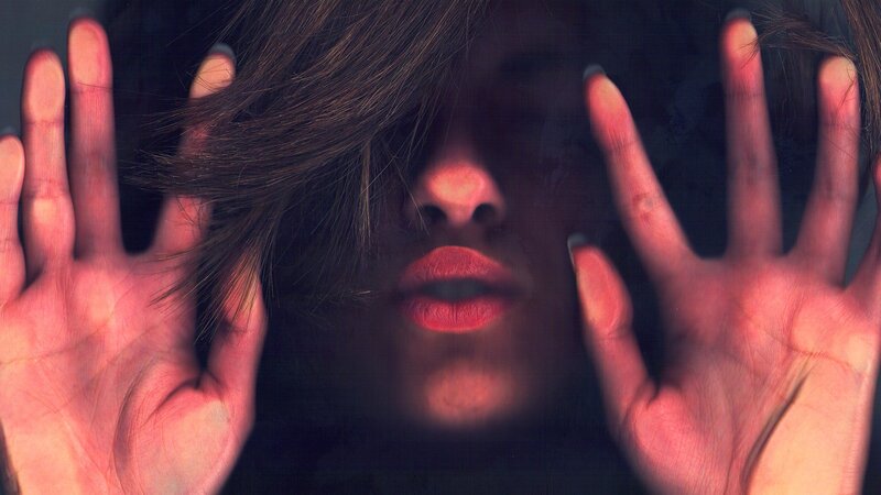 woman with hands on glass