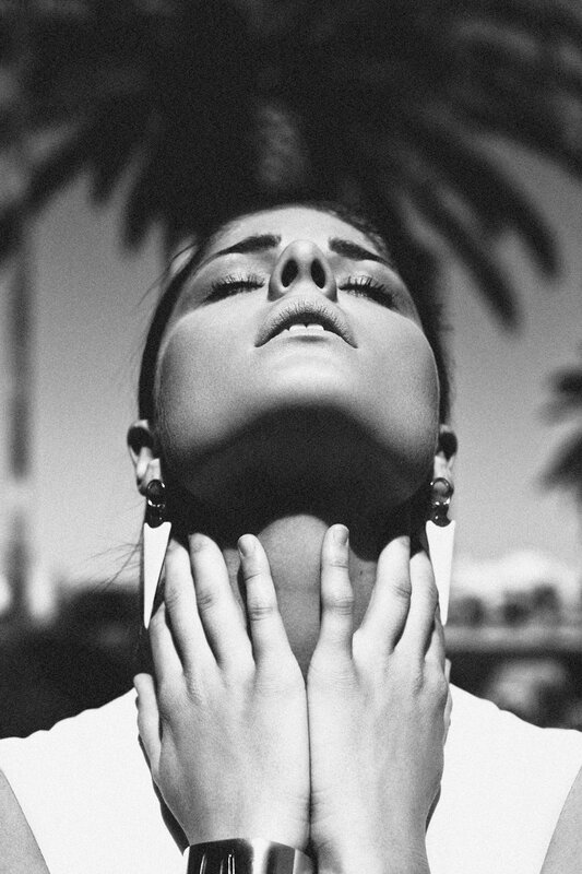 woman with hands on neck