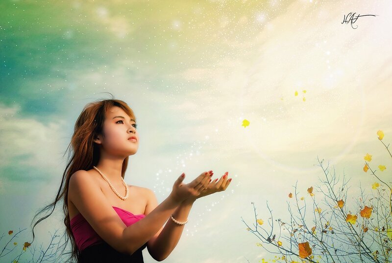 woman with hands raised to sky