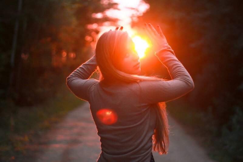 woman with hands to sun