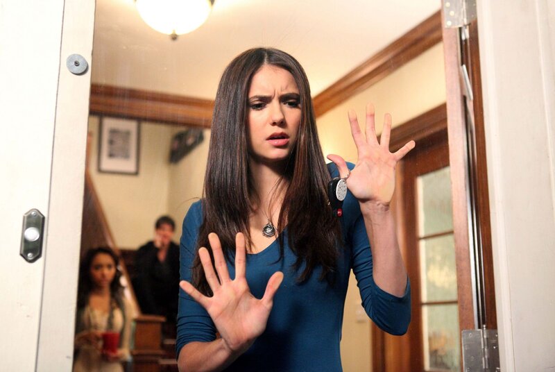 Woman with hands up in hallway
