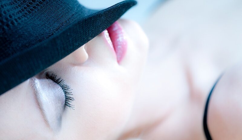 woman with hat and closed eyes
