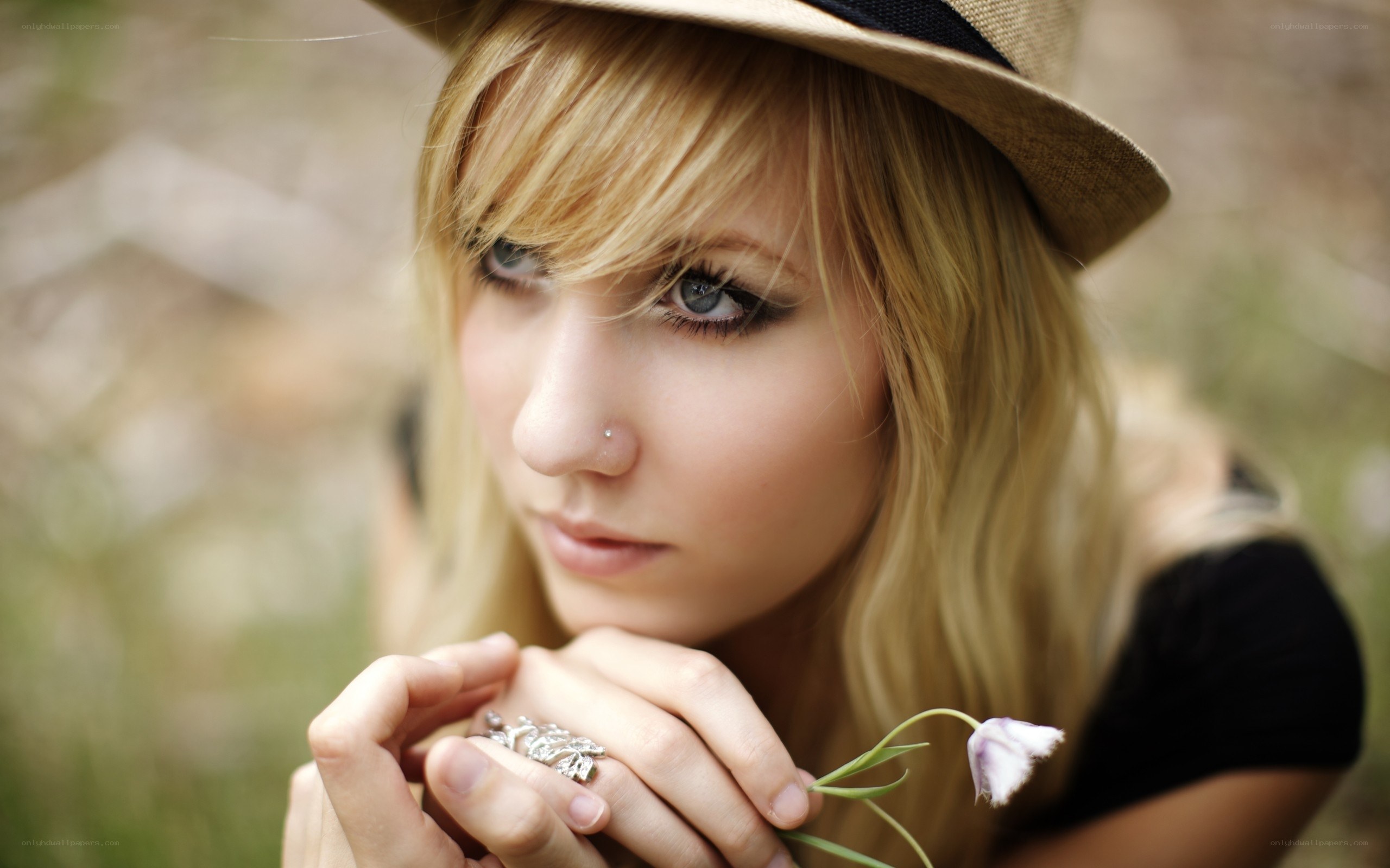 woman with hat holding flower