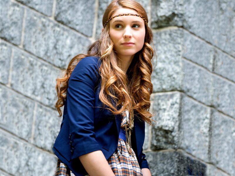 woman with headband and blazer