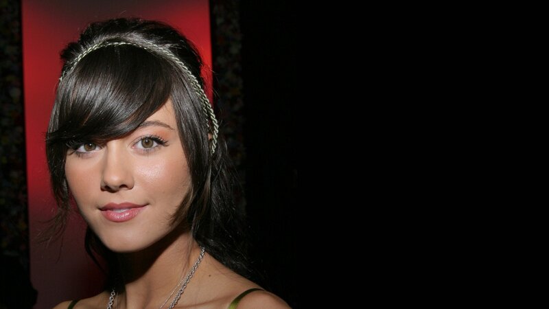 woman with headband and green top