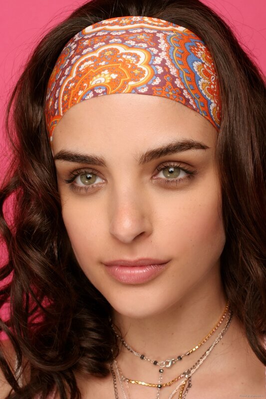 woman with headband and necklaces