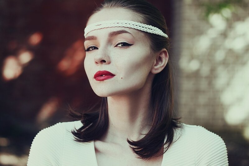woman with headband and red lipstick