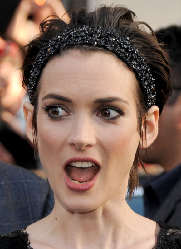 woman with headband and surprised expression