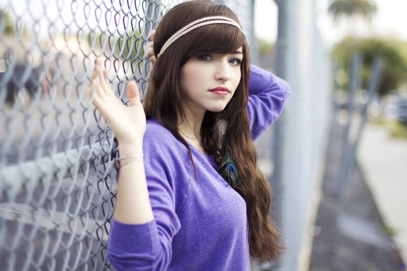 woman with headband by fence