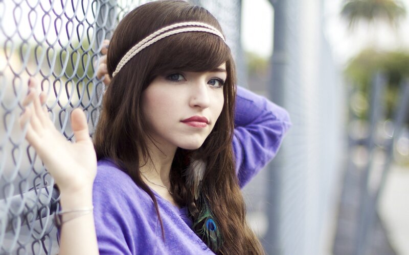 woman with headband by fence