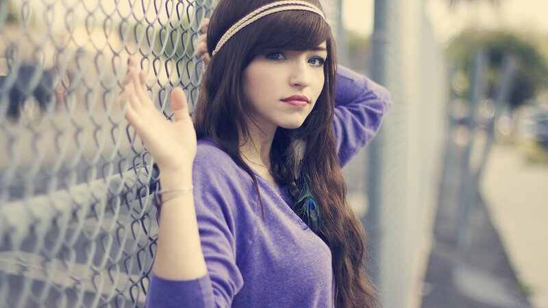 woman with headband by fence