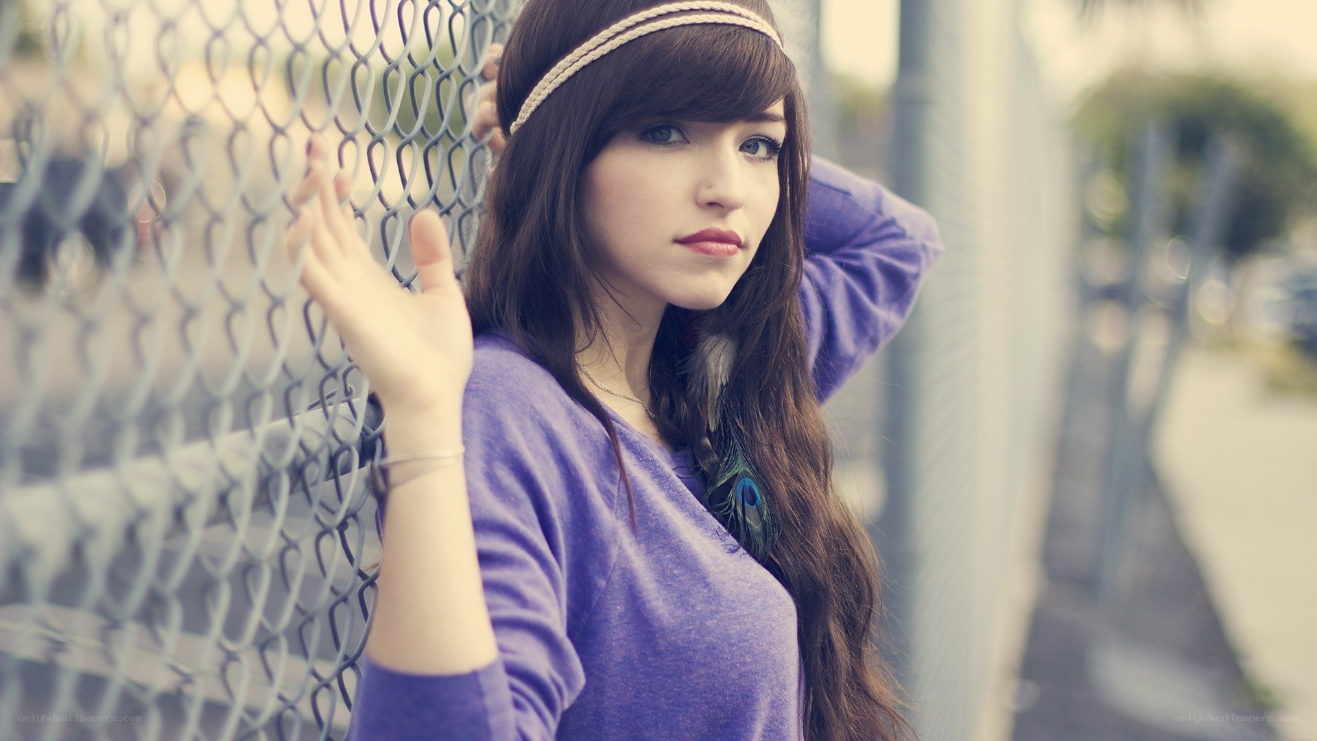 woman with headband by fence