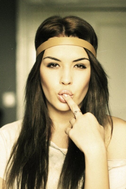 woman with headband making a gesture