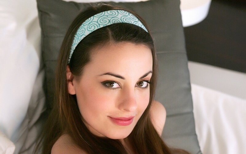 woman with headband smiling