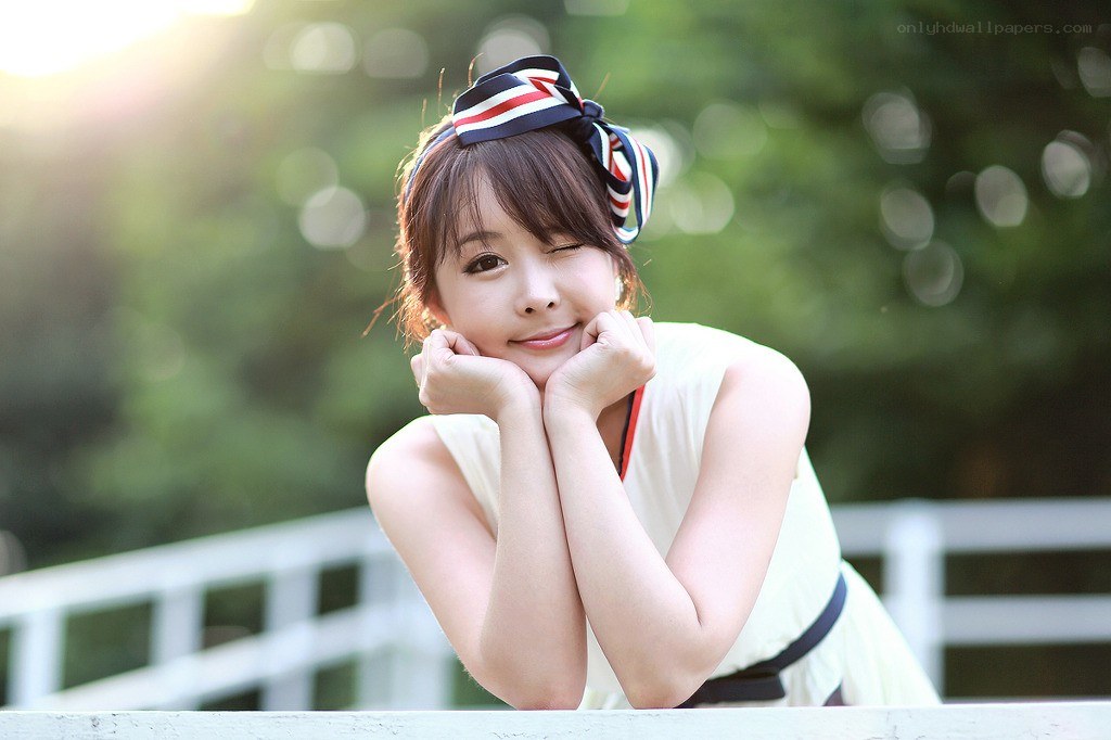 woman with headband winking