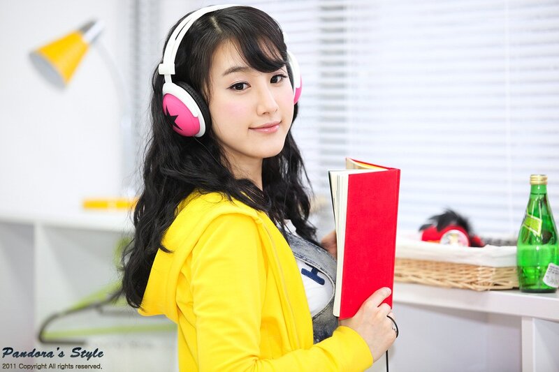 woman with headphones and book