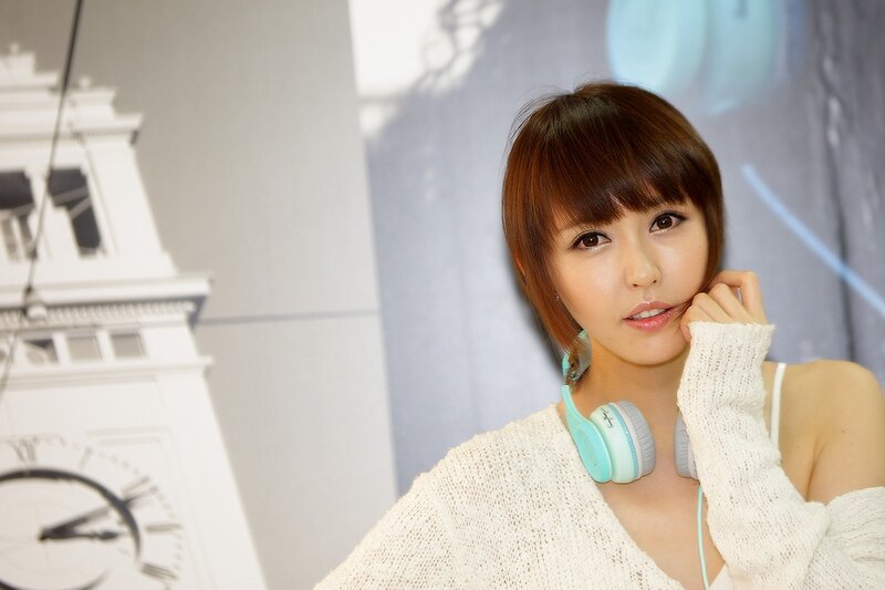 woman with headphones and clock