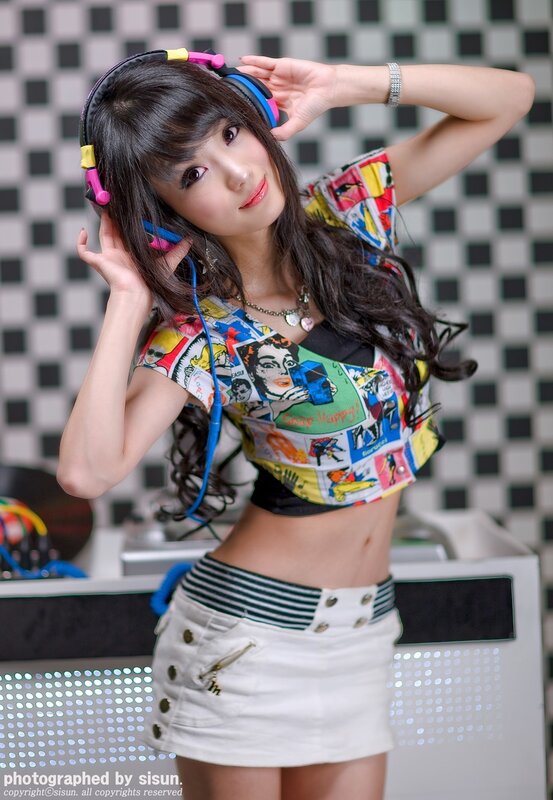 woman with headphones and comic shirt