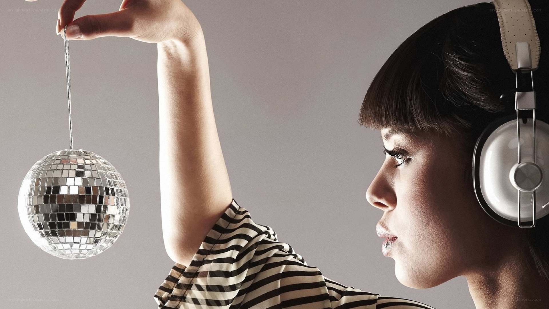 woman with headphones and disco ball