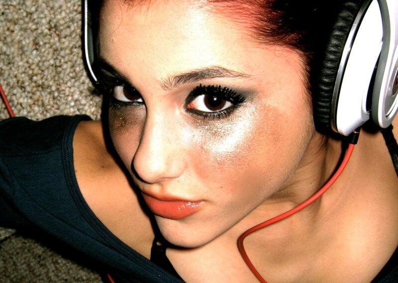 woman with headphones and glitter makeup