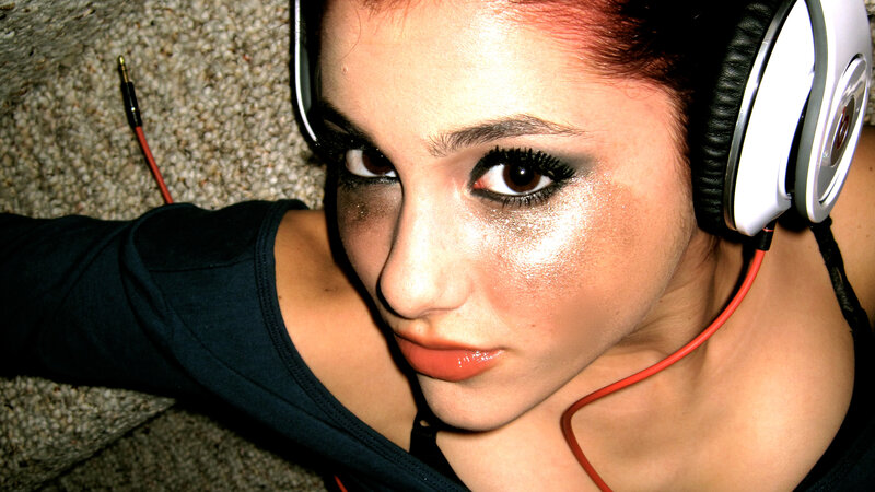 woman with headphones and glitter makeup