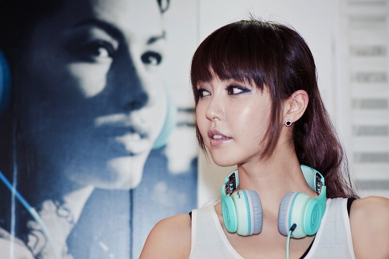woman with headphones around neck