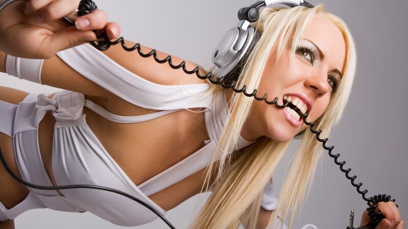 woman with headphones biting cord