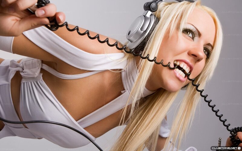 woman with headphones biting cord