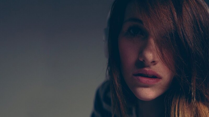 woman with headphones in dim light