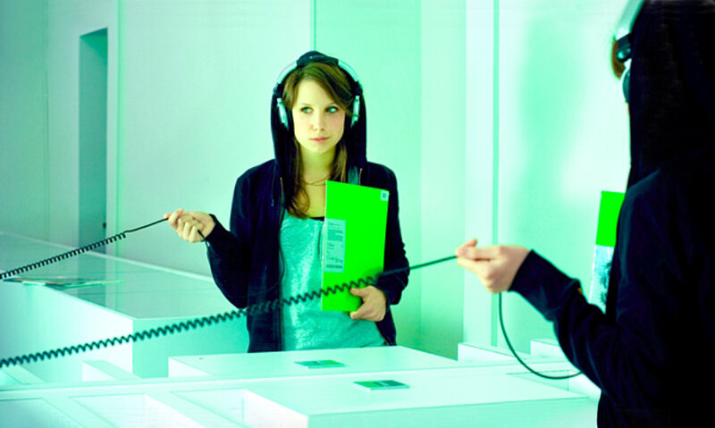 woman with headphones in gallery