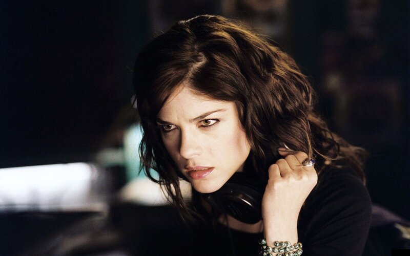 woman with headphones looking intensely