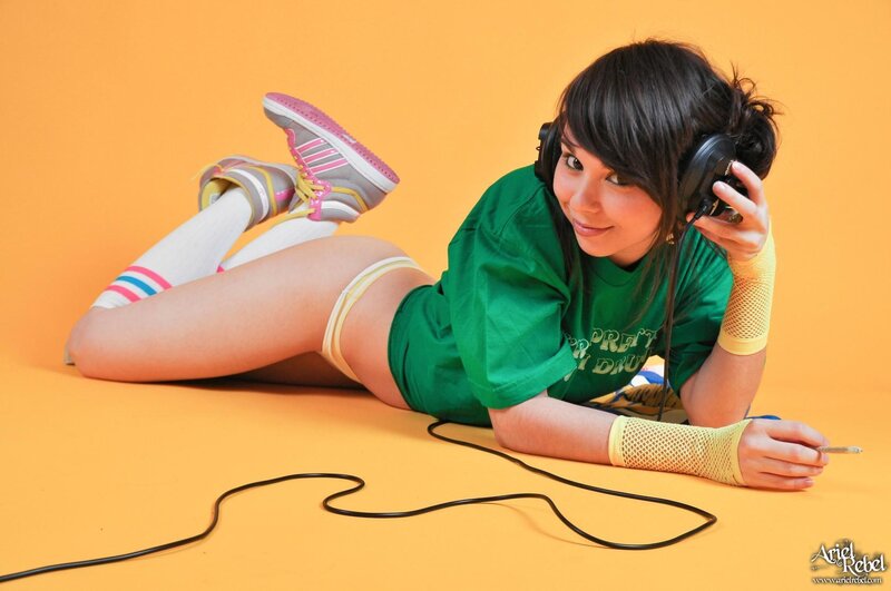 woman with headphones lying on floor