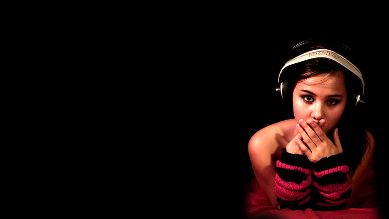 woman with headphones on black