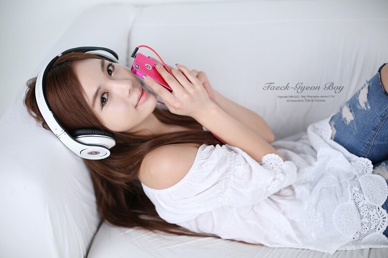 woman with headphones on couch