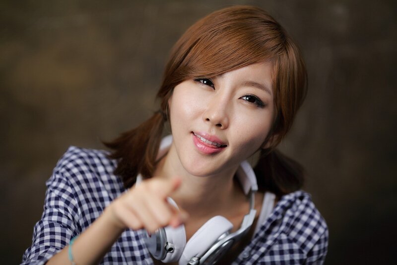 woman with headphones pointing