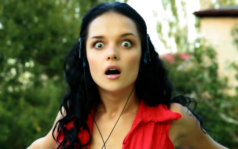 woman with headphones surprised
