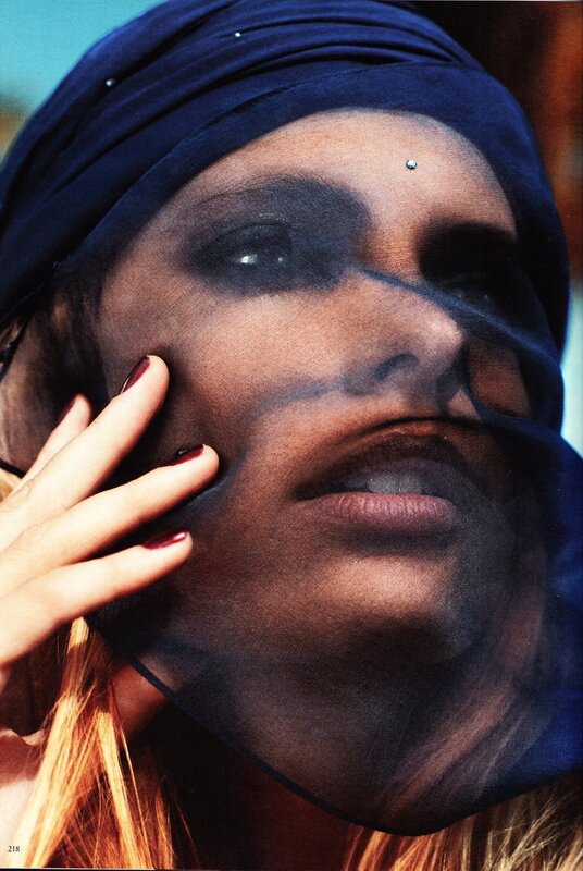 woman with headscarf and dark makeup