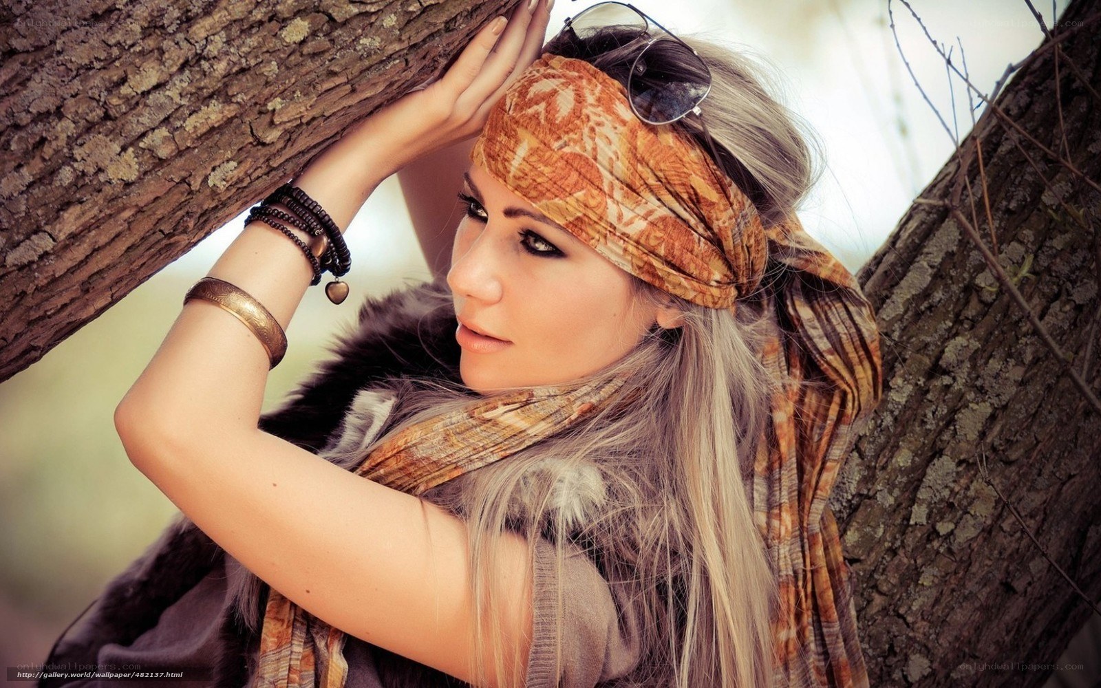 woman with headscarf by tree