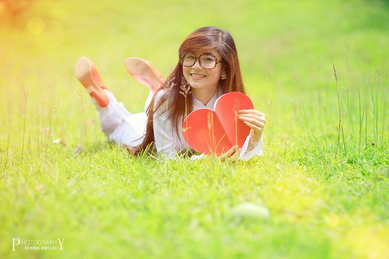 Woman with heart on grass