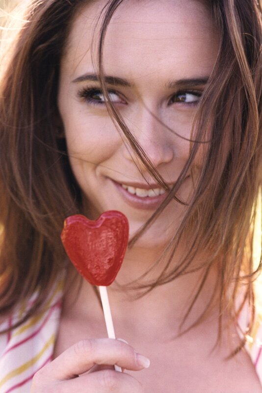 woman with heart-shaped lollipop