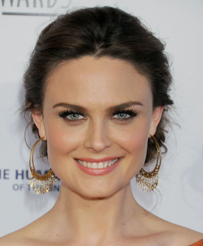 woman with hoop earrings smiling