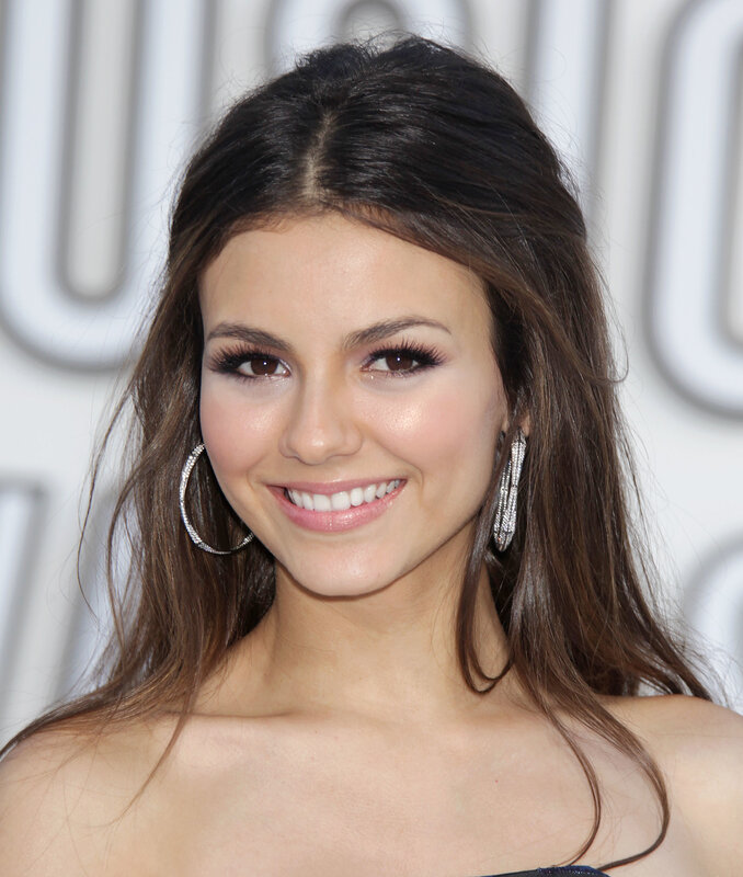 woman with hoop earrings smiling
