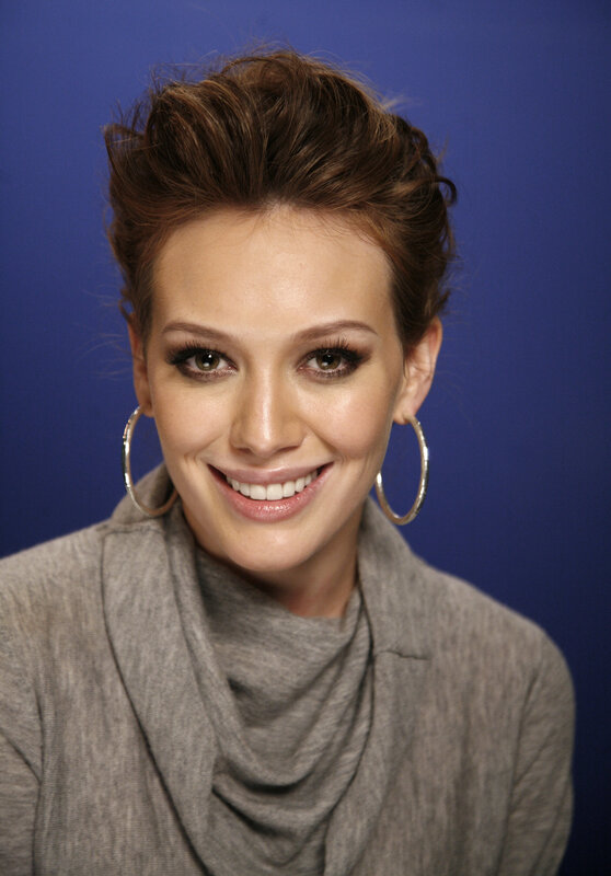 woman with hoop earrings smiling