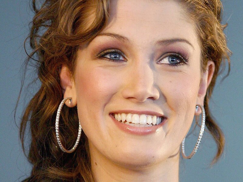 woman with hoop earrings smiling